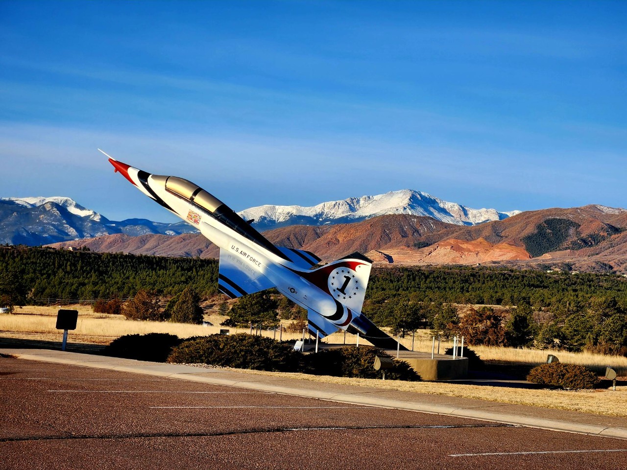 An Air Force Thunderbird aircraft displayed at the entrance of the Air Force Academy.